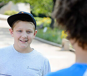 youth with baseball cap