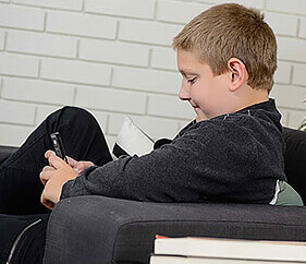 young boy looking at mobile phone