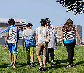 teens walking on the grass