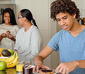 three teens making lunch