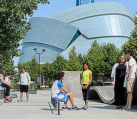 teens sitting in front of museum