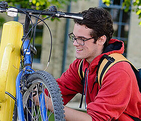 teen fixing bike