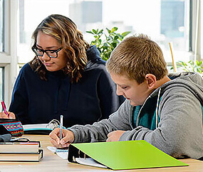 two youth doing schoolwork